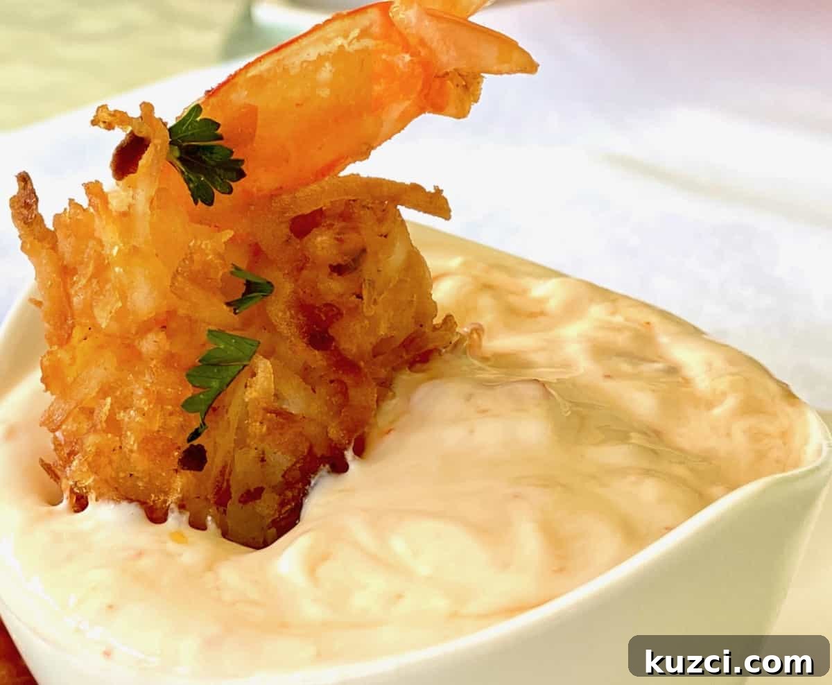 Coconut fried shrimp dipped in dipping sauce.