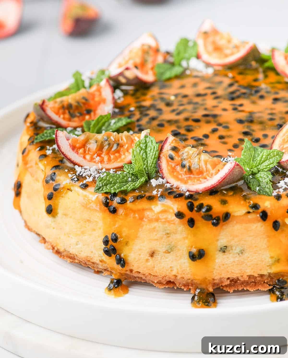 Passion Fruit Cheesecake Recipe with Tropical Glaze 8 Close up on the sides of the cake with the passion fruit coulis dripping down.