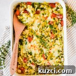 Simple Ground Turkey Recipes That Taste Delicious 14 Large white baking dish with spaghetti squash feta cheese casserole recipe with wooden spoon in dish.