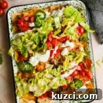 Simple Ground Turkey Recipes That Taste Delicious 16 ground turkey nachos on large sheet pan topped with lettuce, cherry tomatoes and sour cream.
