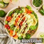 Simple Ground Turkey Recipes That Taste Delicious 4 big bowl of ranch taco salad dressed with creamy jalapeño sauce before tossing.