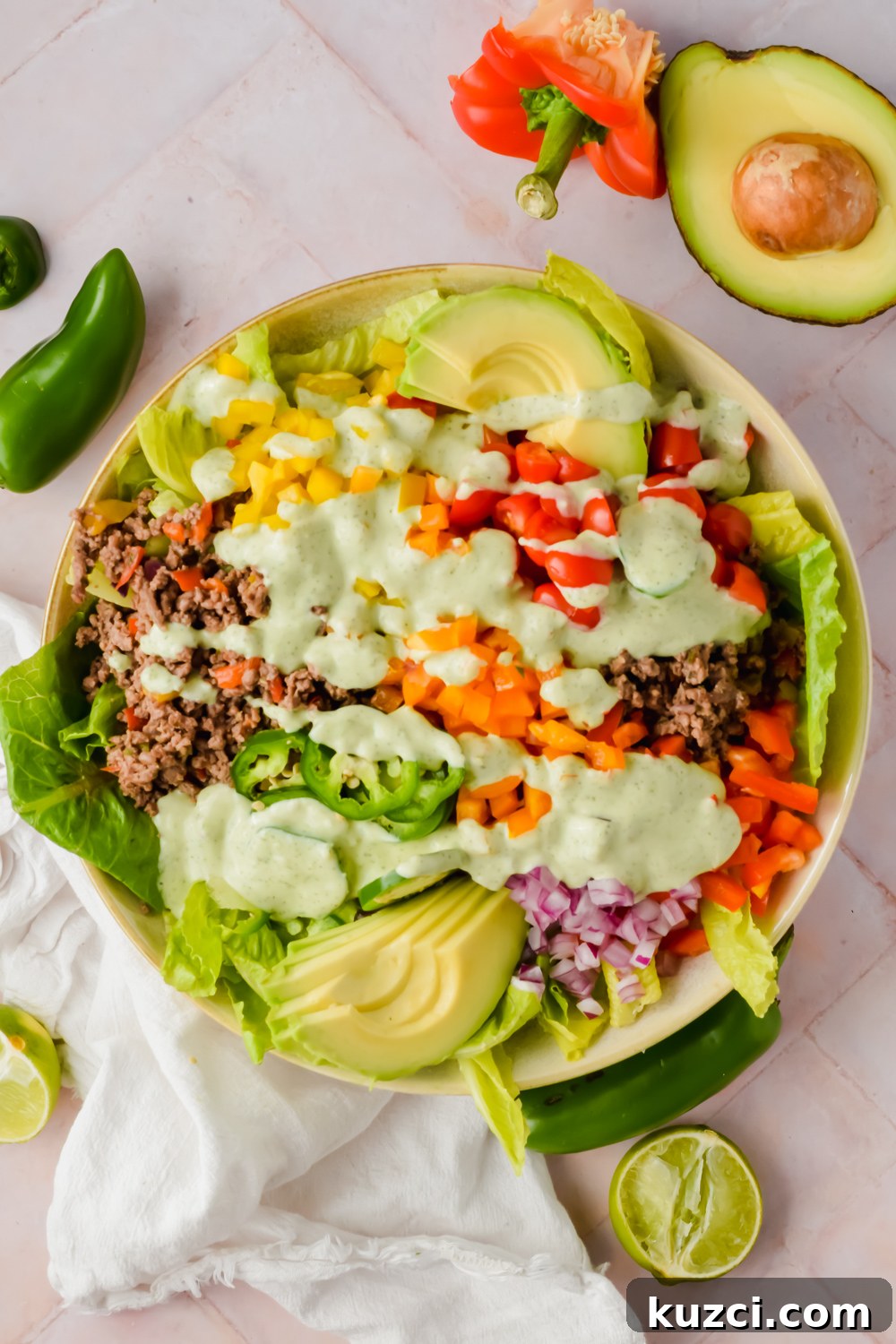 Simple Ground Turkey Recipes That Taste Delicious 5 big bowl of ranch taco salad dressed with creamy jalapeño sauce before tossing.