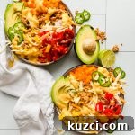 Simple Ground Turkey Recipes That Taste Delicious 6 two bowls loaded with taco salad on a white tiled background.