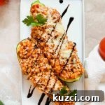 Simple Ground Turkey Recipes That Taste Delicious 8 Close up of cooked Ground Turkey Zucchini Boats in an oven safe dish.