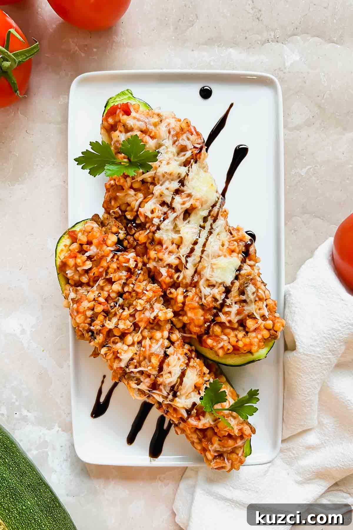 Simple Ground Turkey Recipes That Taste Delicious 9 Close up of cooked Ground Turkey Zucchini Boats in an oven safe dish.
