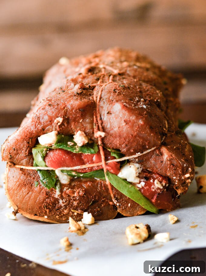 Stuffed Pork Roast with Roasted Red Peppers Feta and Spinach 6 A tied rolled pork roast stuffed with spinach, roasted red peppers, and feta cheese.