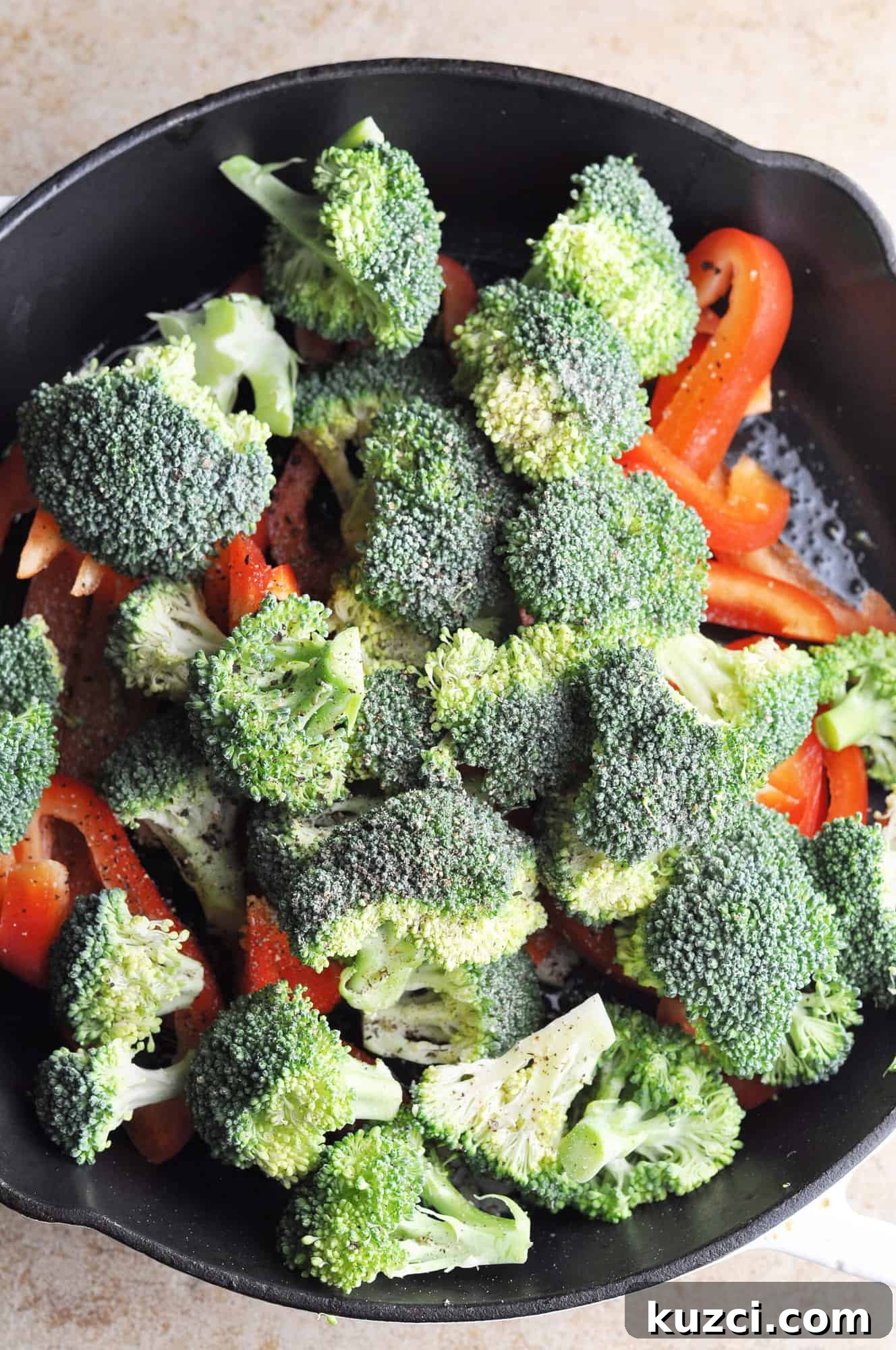 Broccoli and red peppers in cast iron skillet ready to cook.