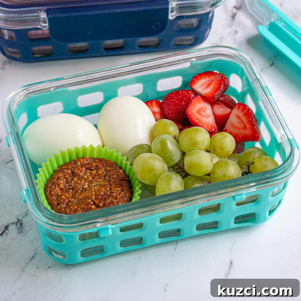 Protein-Packed Breakfast Cookies for Busy Mornings 13 A breakfast bistro box with hard boiled eggs, fruits, and a muffin.