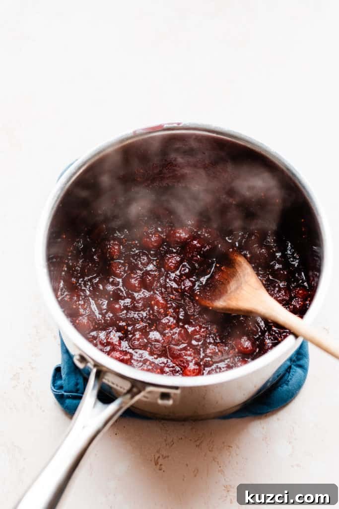 Gouda Puff Pastry Bites with Spiced Rum Cranberry Sauce 4 A pot of steaming cranberry sauce