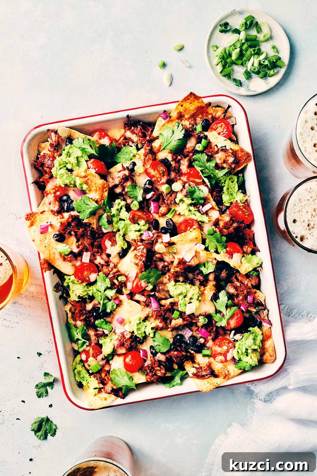 Plant-Based Pulled Pork Nachos 6 Full pan of pulled pork nachos fresh out of the oven and topped with cilantro