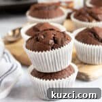 Nutella Chocolate Muffins Recipe 11 Chocolate Nutella muffins in white paper cases.