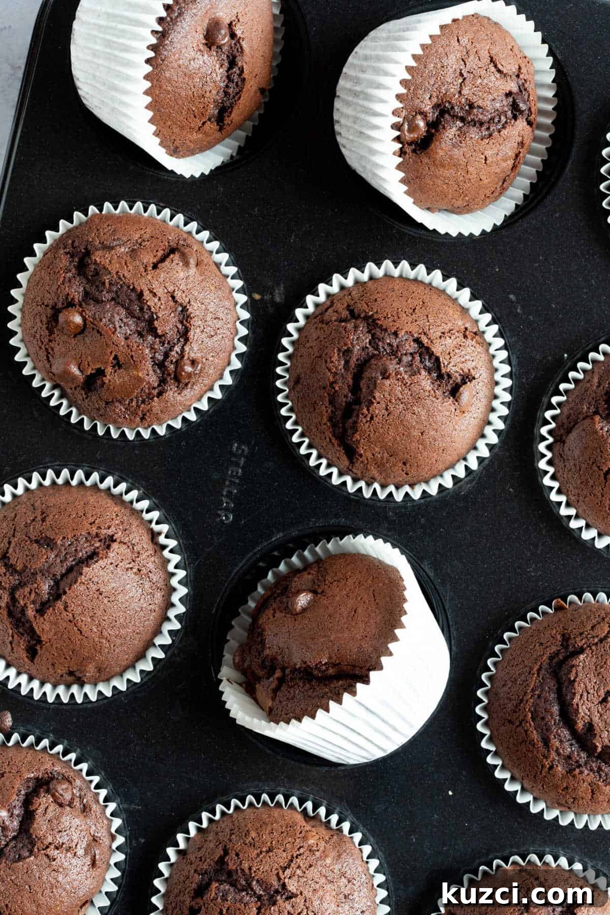 Nutella Chocolate Muffins Recipe 6 Chocolate nutella muffins in a muffin tin.