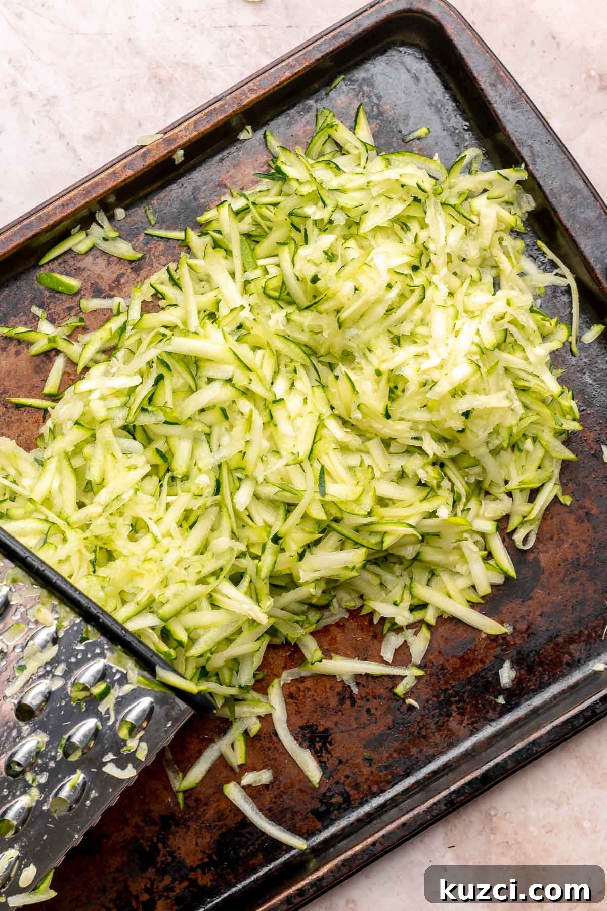 Crispy Corn and Zucchini Fritters with Herbed Yogurt Sauce 5 Grated zucchini on a cookie sheet.