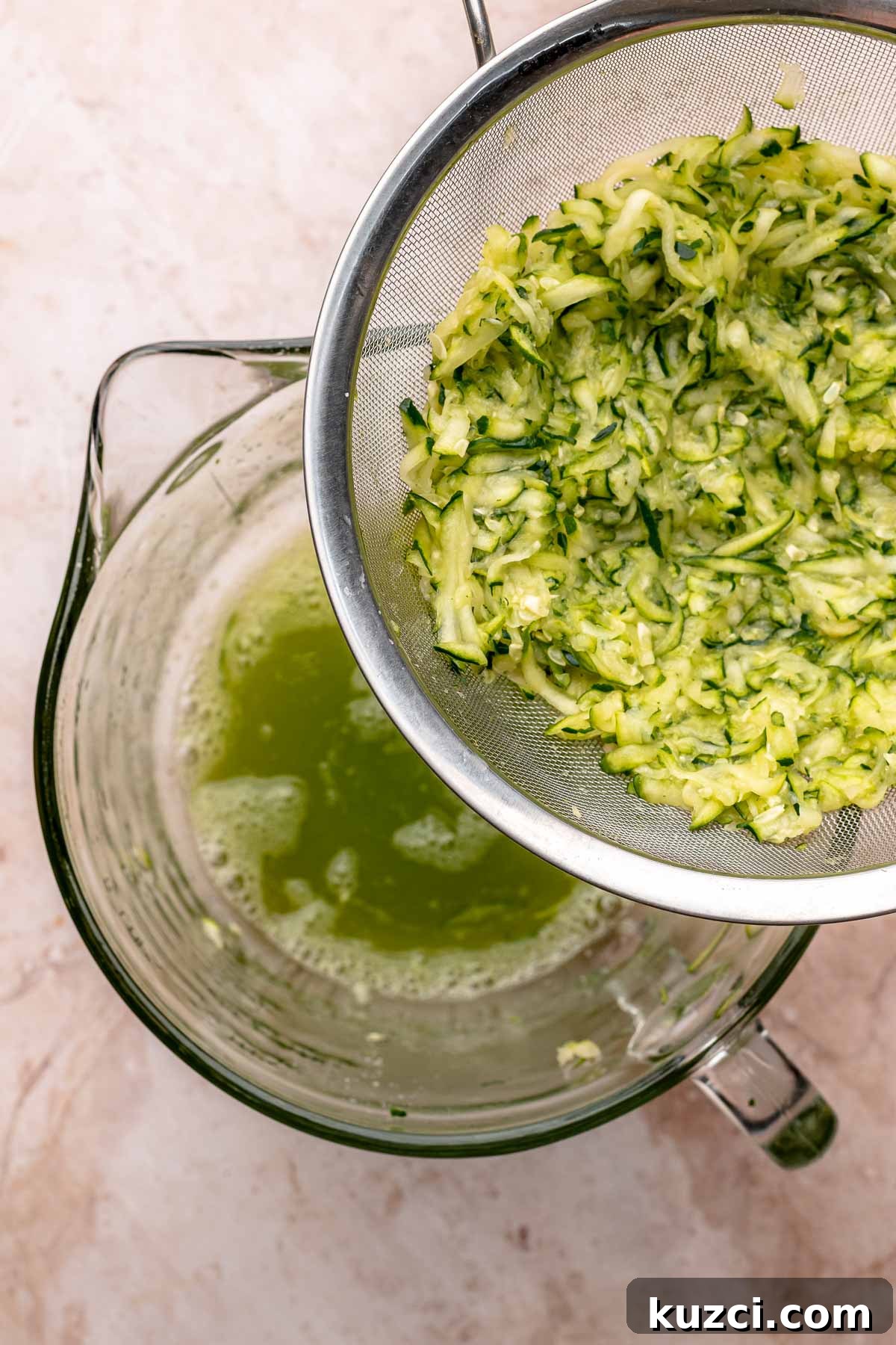 Crispy Corn and Zucchini Fritters with Herbed Yogurt Sauce 6 Zucchini and its juice in a colander and bowl.