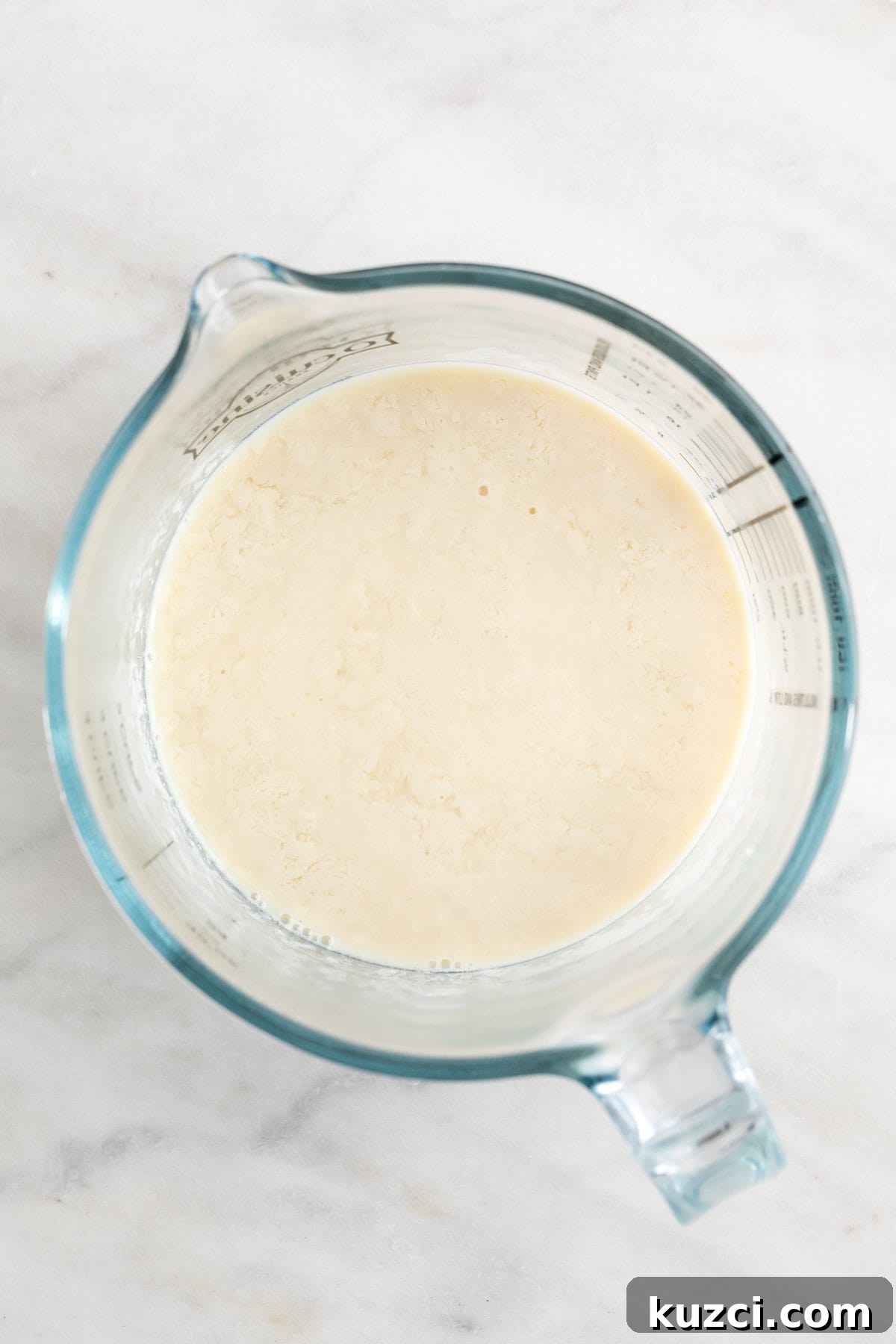 Vegan buttermilk in a measuring cup.
