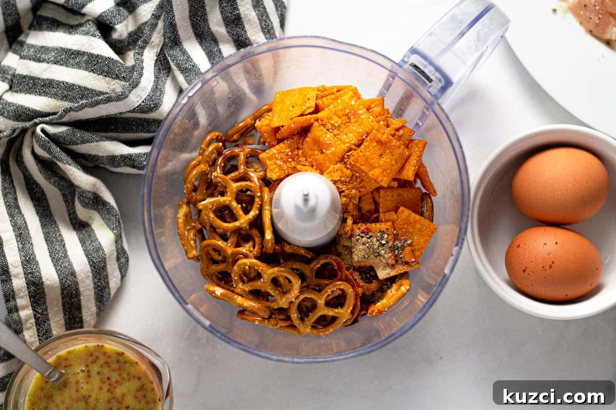 Crispy Oven Fried Chicken Tenders 4 Food processor filled with pretzels and cheez its