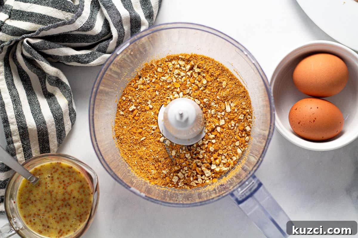 Crispy Oven Fried Chicken Tenders 5 Food processor filled with crushed pretzels and cheez its