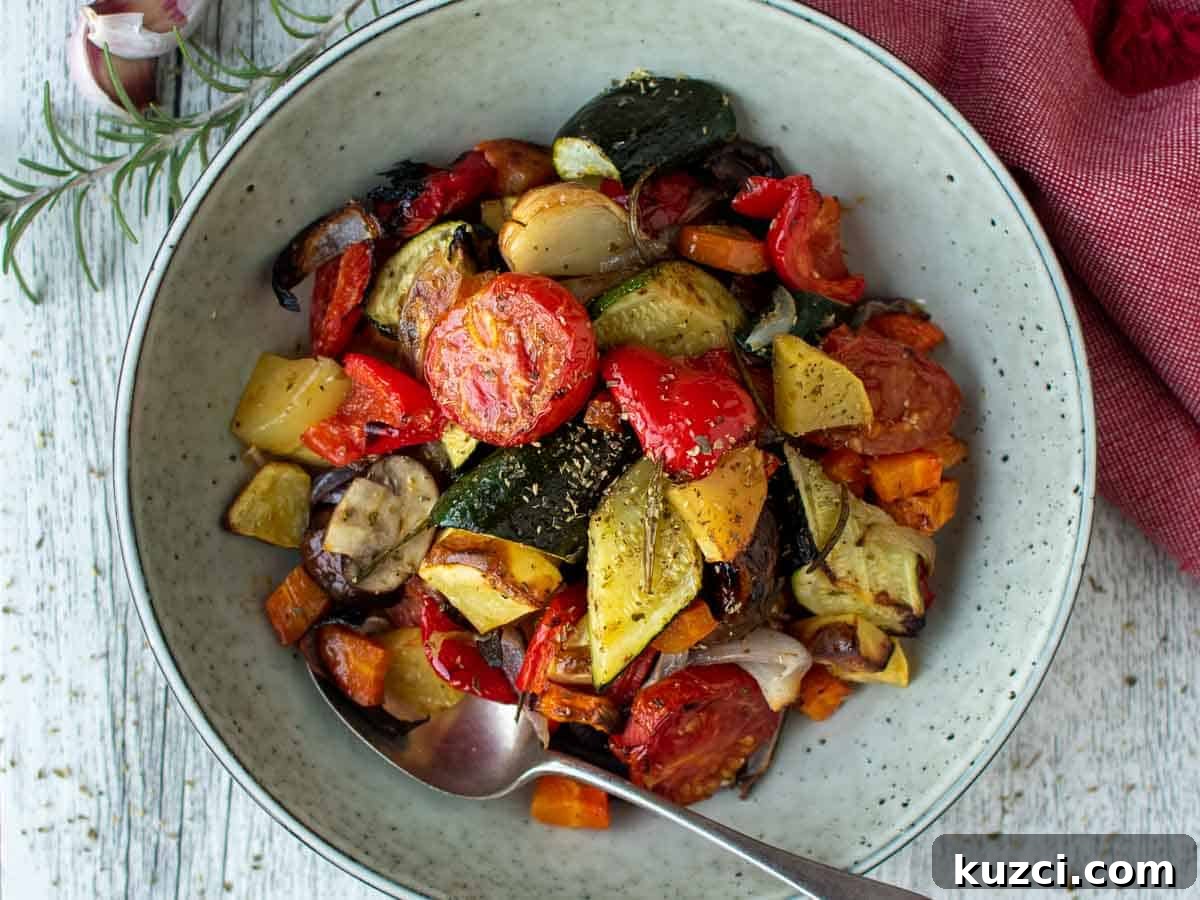 Italian Roasted Vegetables Recipe 8 Assorted colorful chopped and roasted vegetables in a pale green bowl viewed from above.