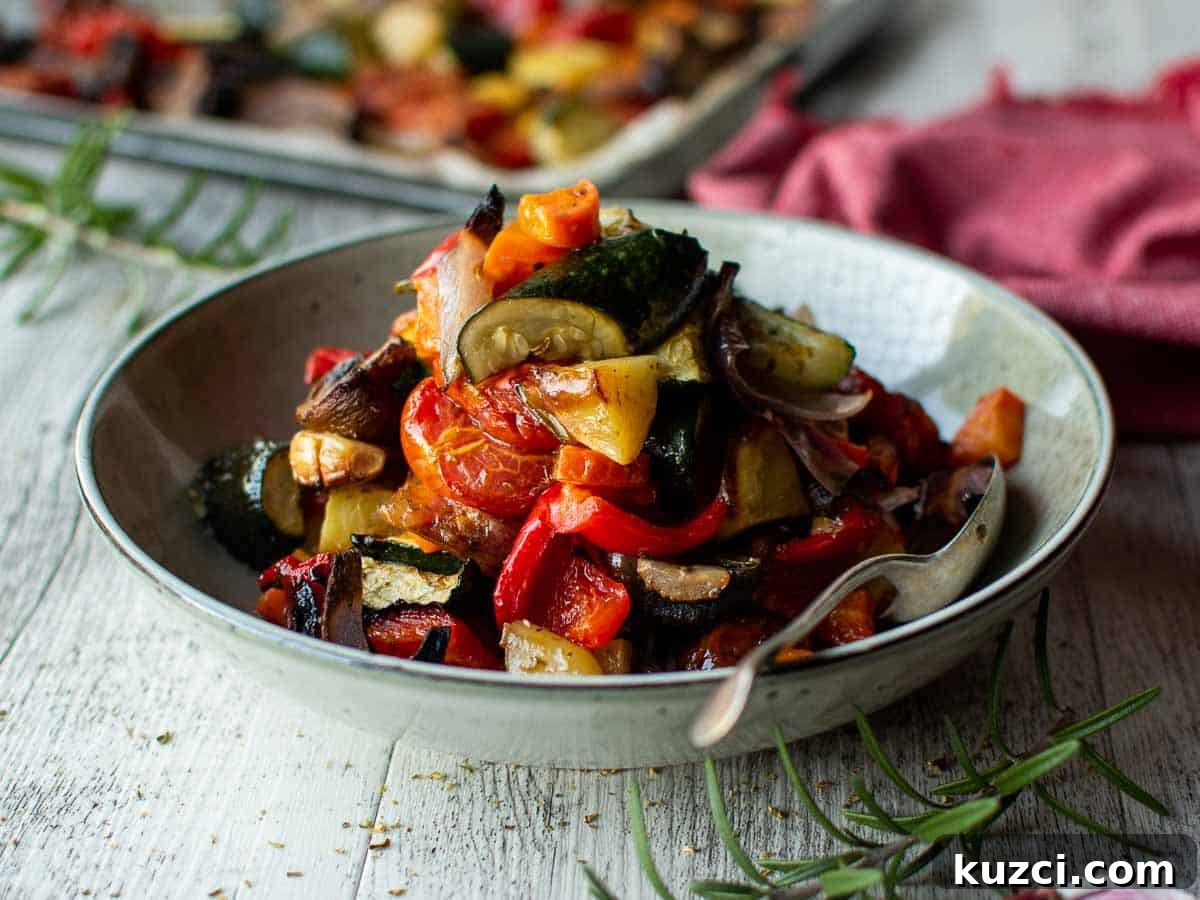 Italian Roasted Vegetables Recipe 9 Assorted chopped and roasted Mediterranean vegetables in a pale green bowl.