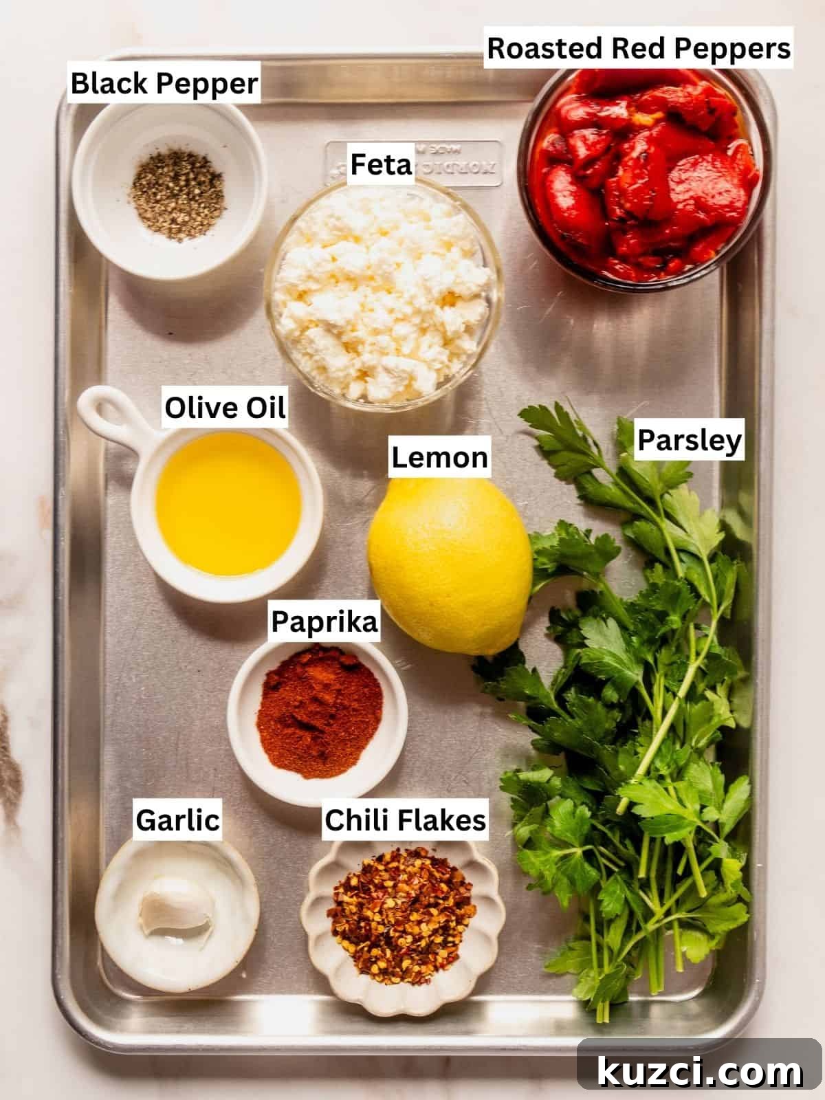 Red pepper feta dip (Greek Tirokafteri or Htipiti) recipe ingredients with individual labels on a metal tray.