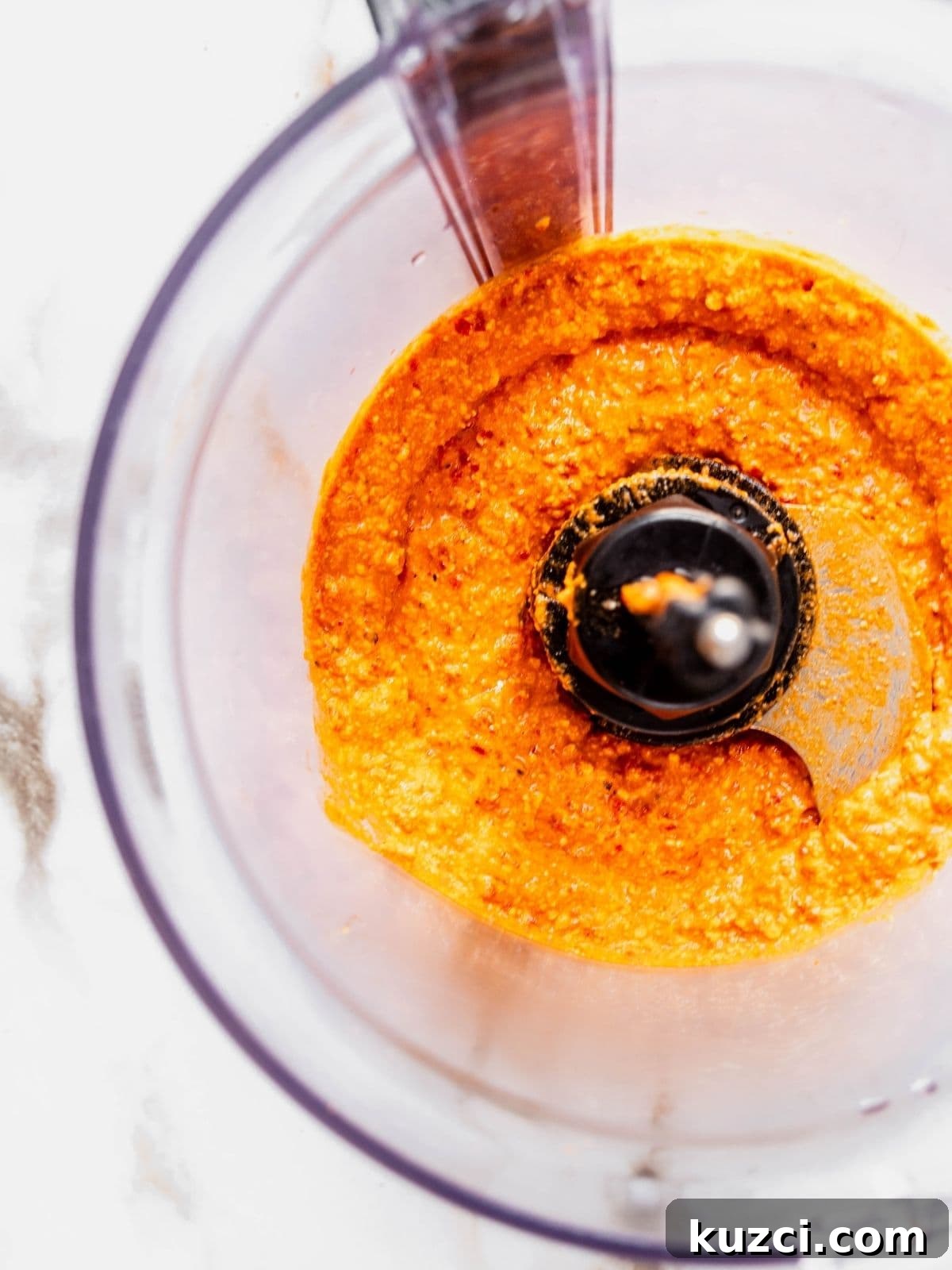 Food processor showing the final smooth consistency of the dip.