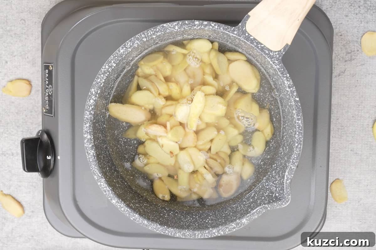 Homemade Crystallized Ginger Candy 4 Water and ginger added to a pan.