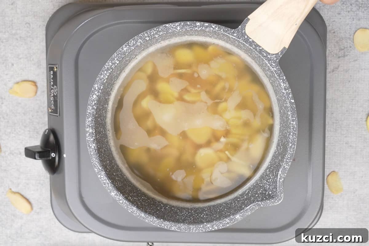Homemade Crystallized Ginger Candy 5 Ginger boiling in water.
