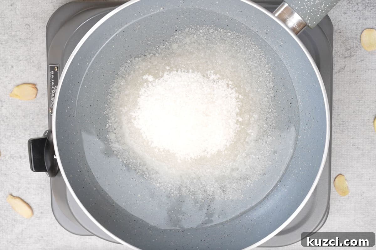 Homemade Crystallized Ginger Candy 7 Water and sugar added to a pan.