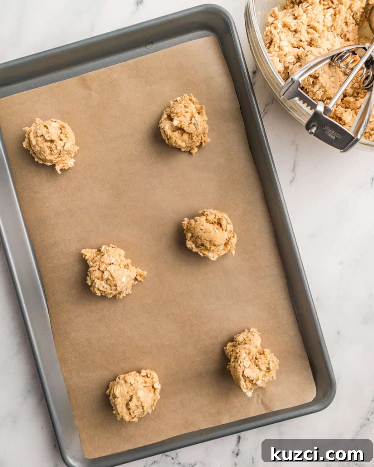 oatmeal cookie dough balls on a sheet pan. 