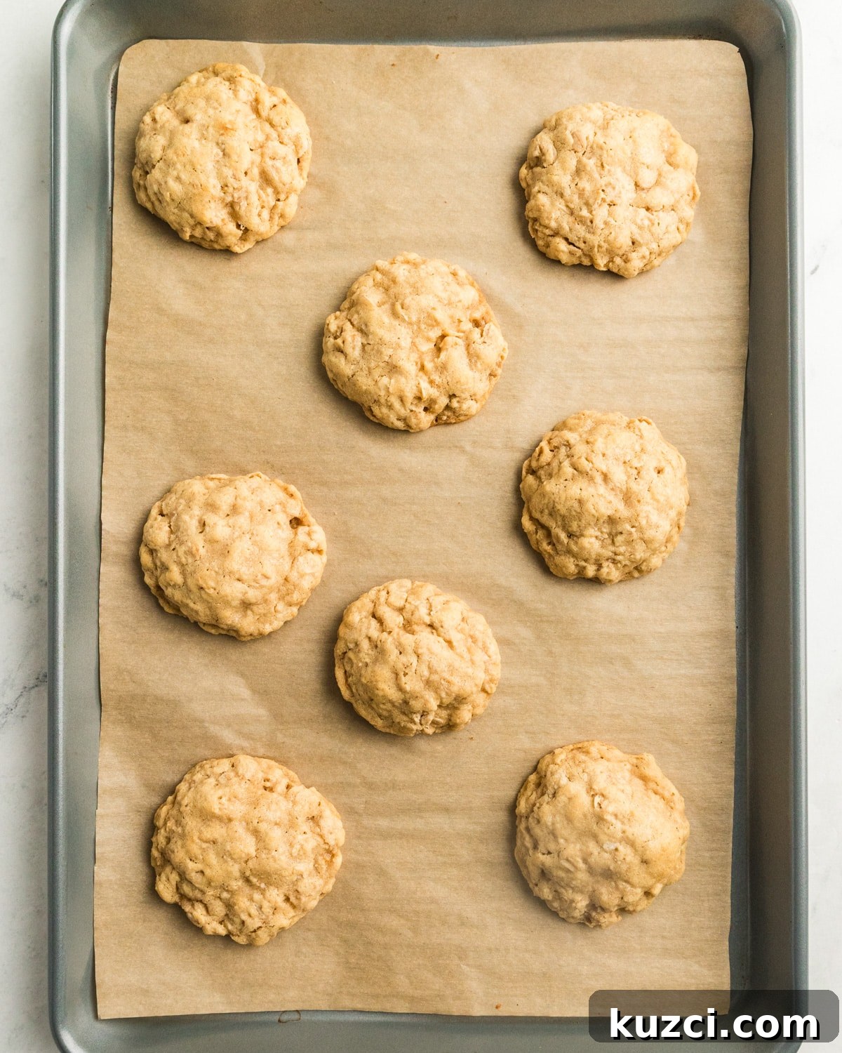 gluten free oatmeal cookies on a sheet pan. 