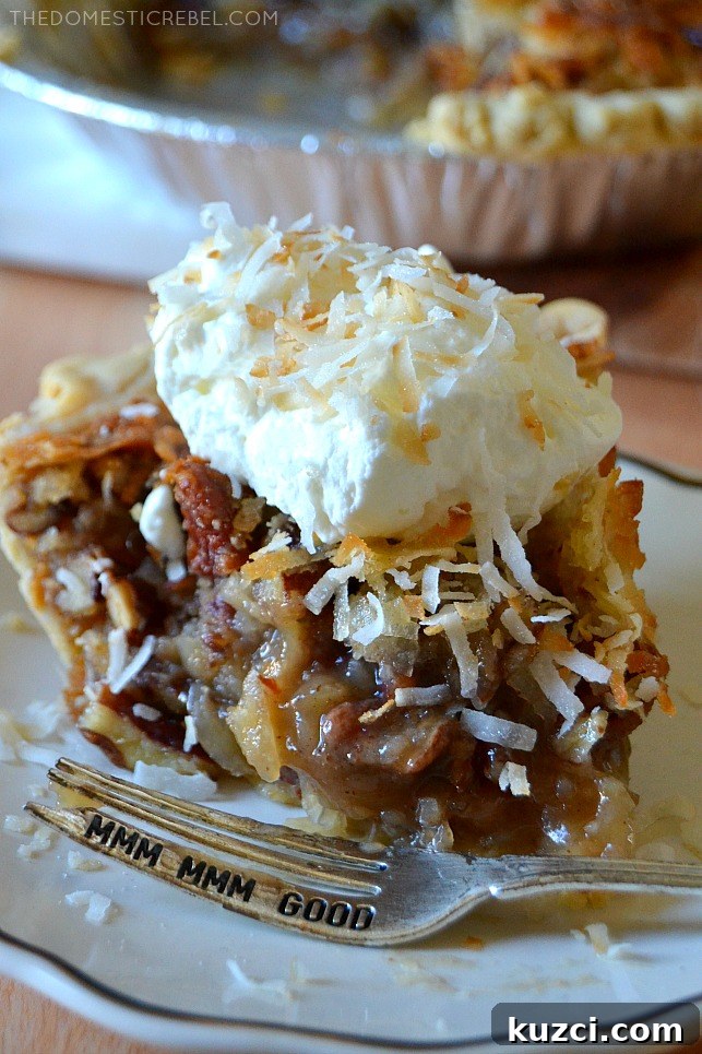Creamy Coconut Pecan Pie Recipe 5 Closeup slice of coconut pecan pie with a bite missing and a silver fork