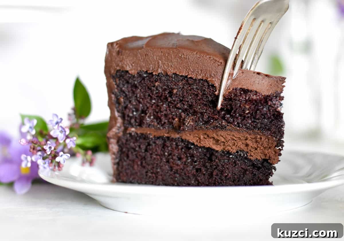 slice of chocolate cake with fork digging in.