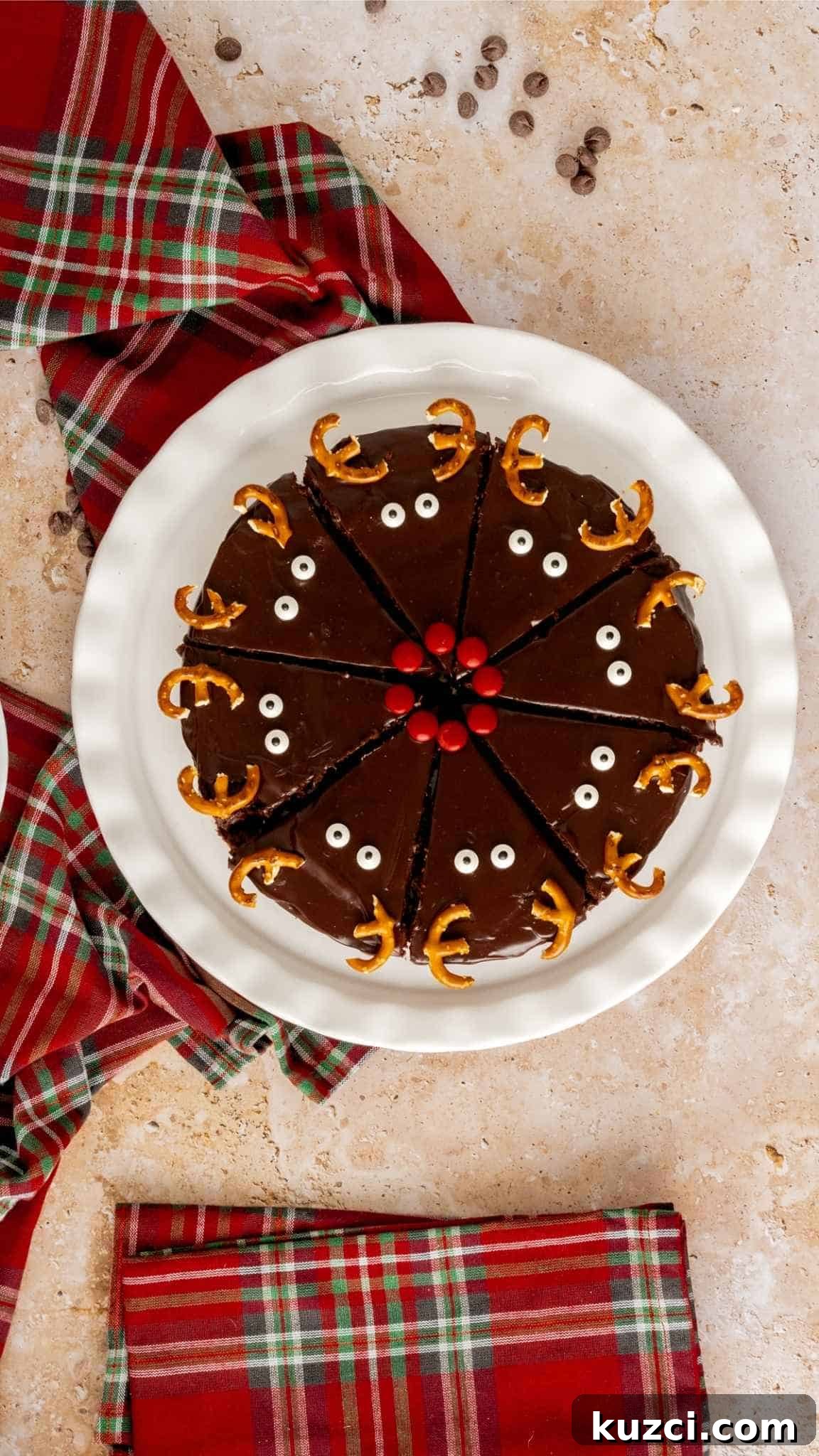 Bird's eye view of triangle cut brownies decorated like reindeers with Christmas napkins in the background.