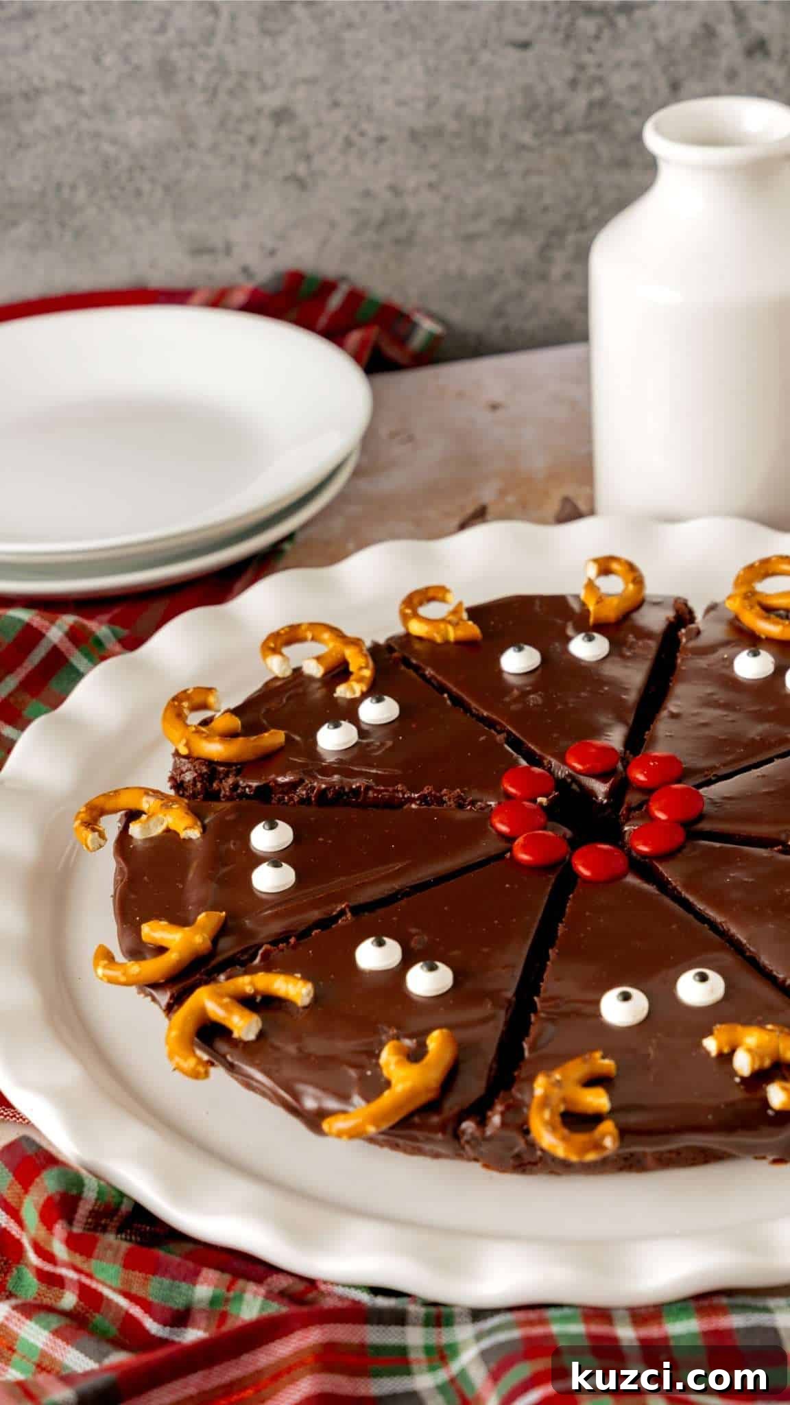 Fudgy Christmas brownies decorated with ganache with reindeer faces.