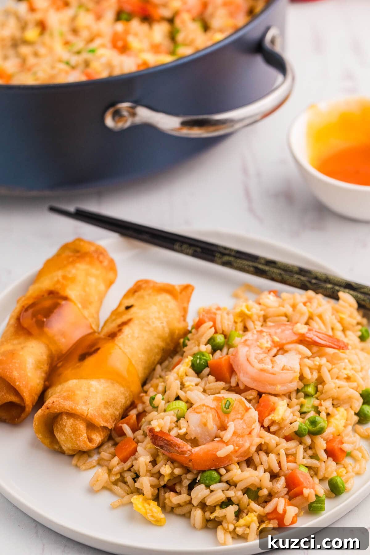 Garlic Shrimp Fried Rice Recipe with Egg and Vegetables 7 The recipe on a plate with spring rolls.