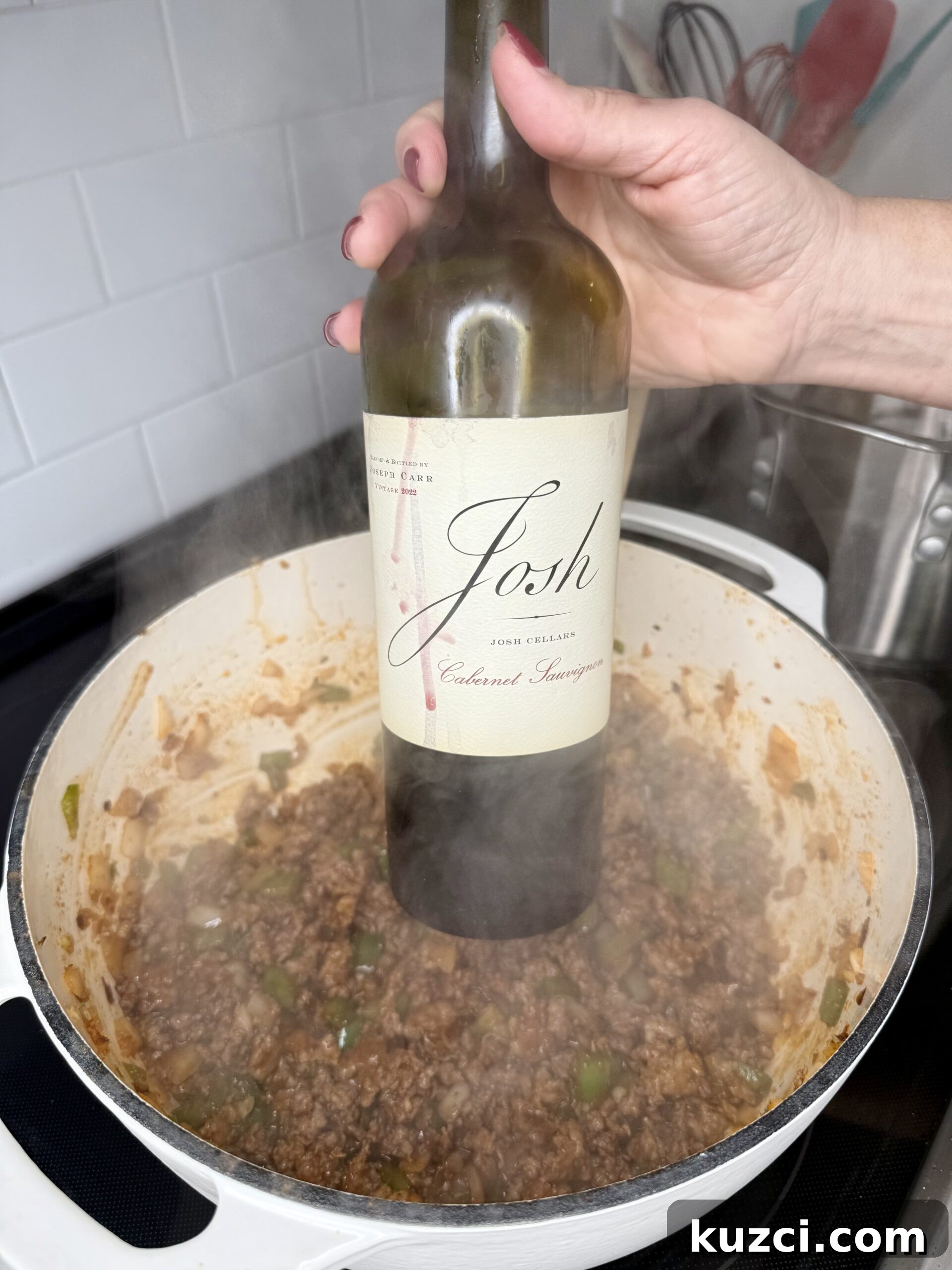 Creamy Sausage and Peppers Fettuccine 16 Adding crushed tomatoes to sausage sauce