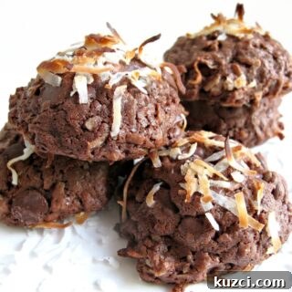 Chocolate Coconut Cookies Recipe 4 Domed chocolate coconut cookies topped with coconut.