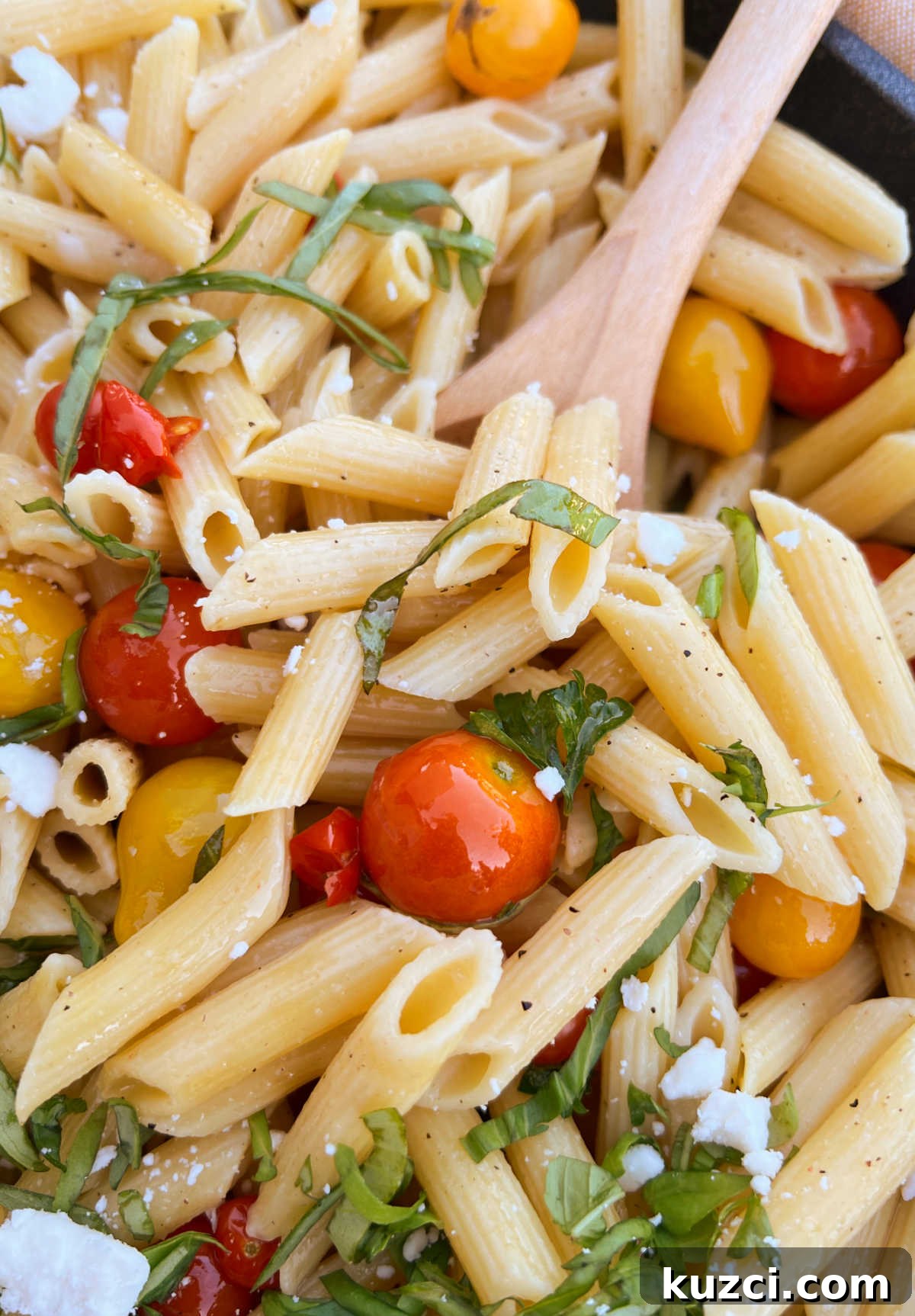 Grape Tomato Pasta Recipe with Garlic and Fresh Basil 2 penne pasta and garden fresh tomatoes and basil in wooden spoon
