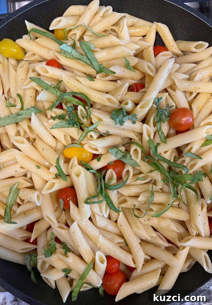 Grape Tomato Pasta Recipe with Garlic and Fresh Basil 5 stir penne pasta with fresh basil and cherry tomatoes in skillet