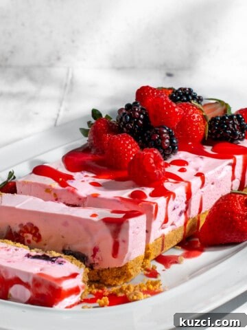 No bake berry cheesecake sliced on a white plate.