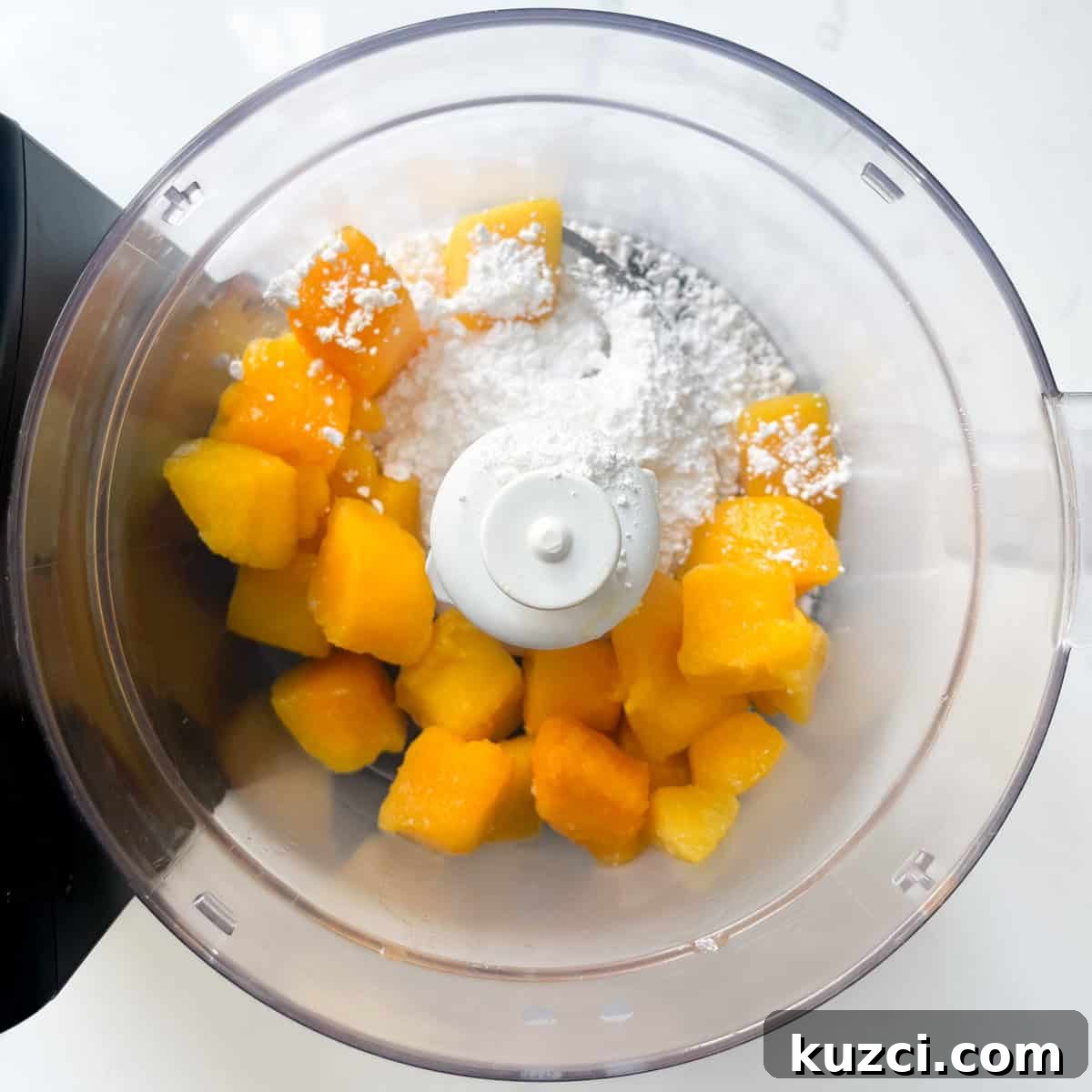 Creamy Mango Mousse Recipe 4 Adding the frozen or fresh mango along with the icing sugar to a food processor.