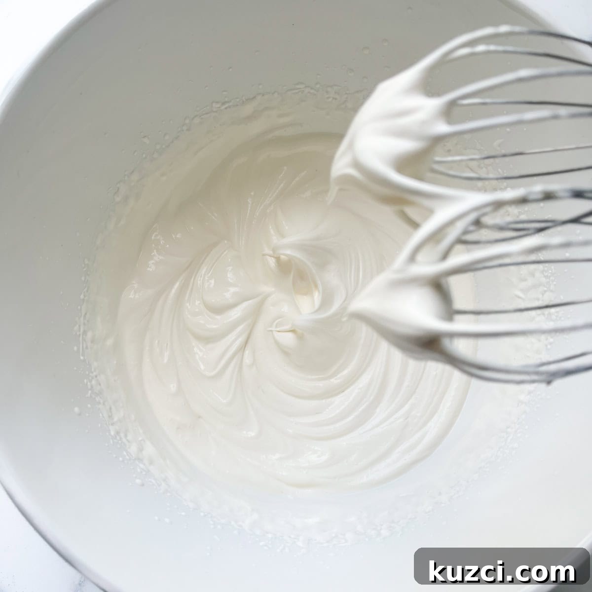 Creamy Mango Mousse Recipe 6 Whipping the double cream for the mango mousse in a large white bowl.