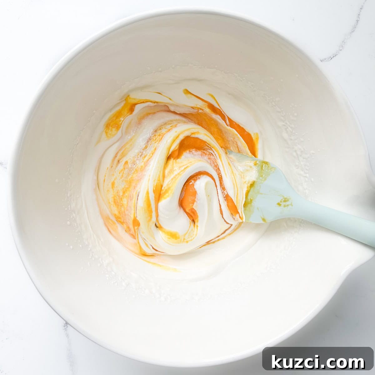 Creamy Mango Mousse Recipe 8 Folding the mango puree into the whipped cream.