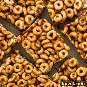 Peanut Butter Chex Bars Recipe 4 A pile of cereal bars on a white plate.