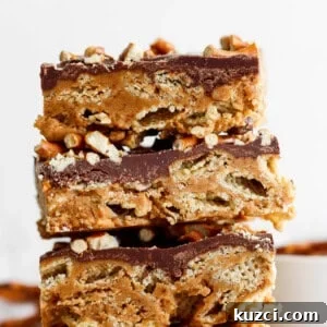Peanut Butter Chex Bars Recipe 8 Stack of three peanut butter rice krispie treats topped with a layer of chocolate and sprinkled with chopped peanuts.