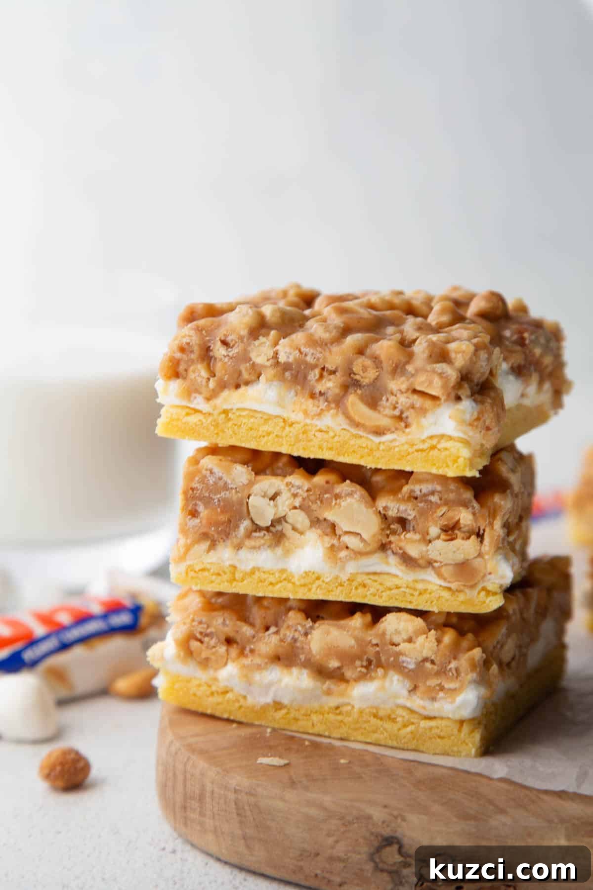 pay day cookie bars stacked on a wooden board.