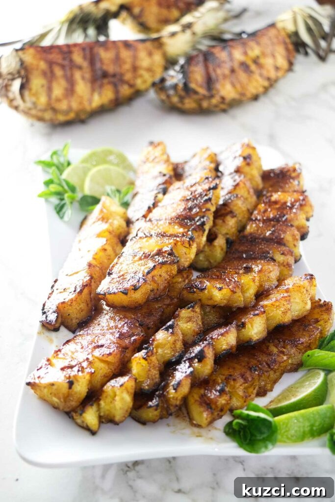 Cinnamon Sugar Grilled Pineapple Recipe 5 A serving platter with grilled pineapple and lime slices.