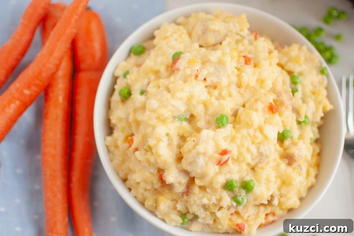 33 Fall Dinner Recipes Packed With Comfort Food Favorites 11 A bowl of Slow Cooker Chicken and Rice is next to whole carrots on a light blue cloth.