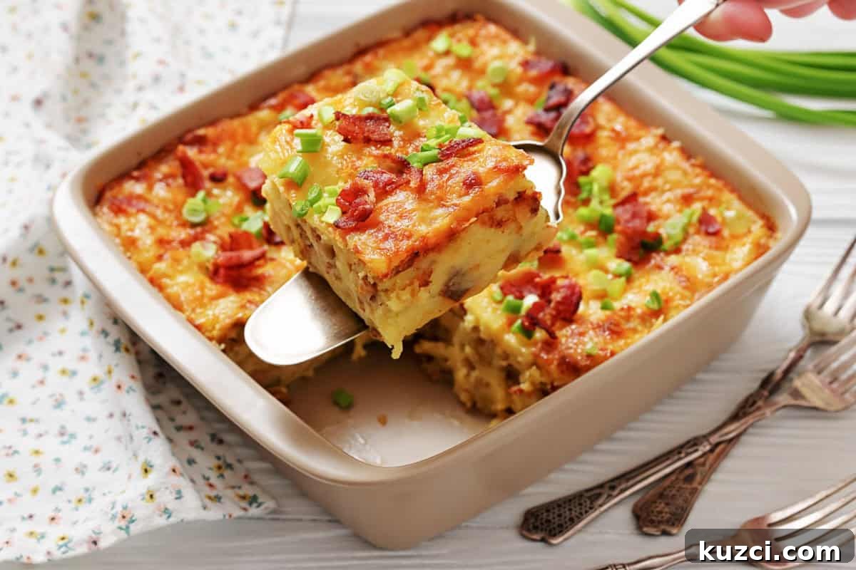 33 Fall Dinner Recipes Packed With Comfort Food Favorites 14 A baked casserole topped with chopped green onions and bacon pieces, with one square being served from the dish using a spatula.