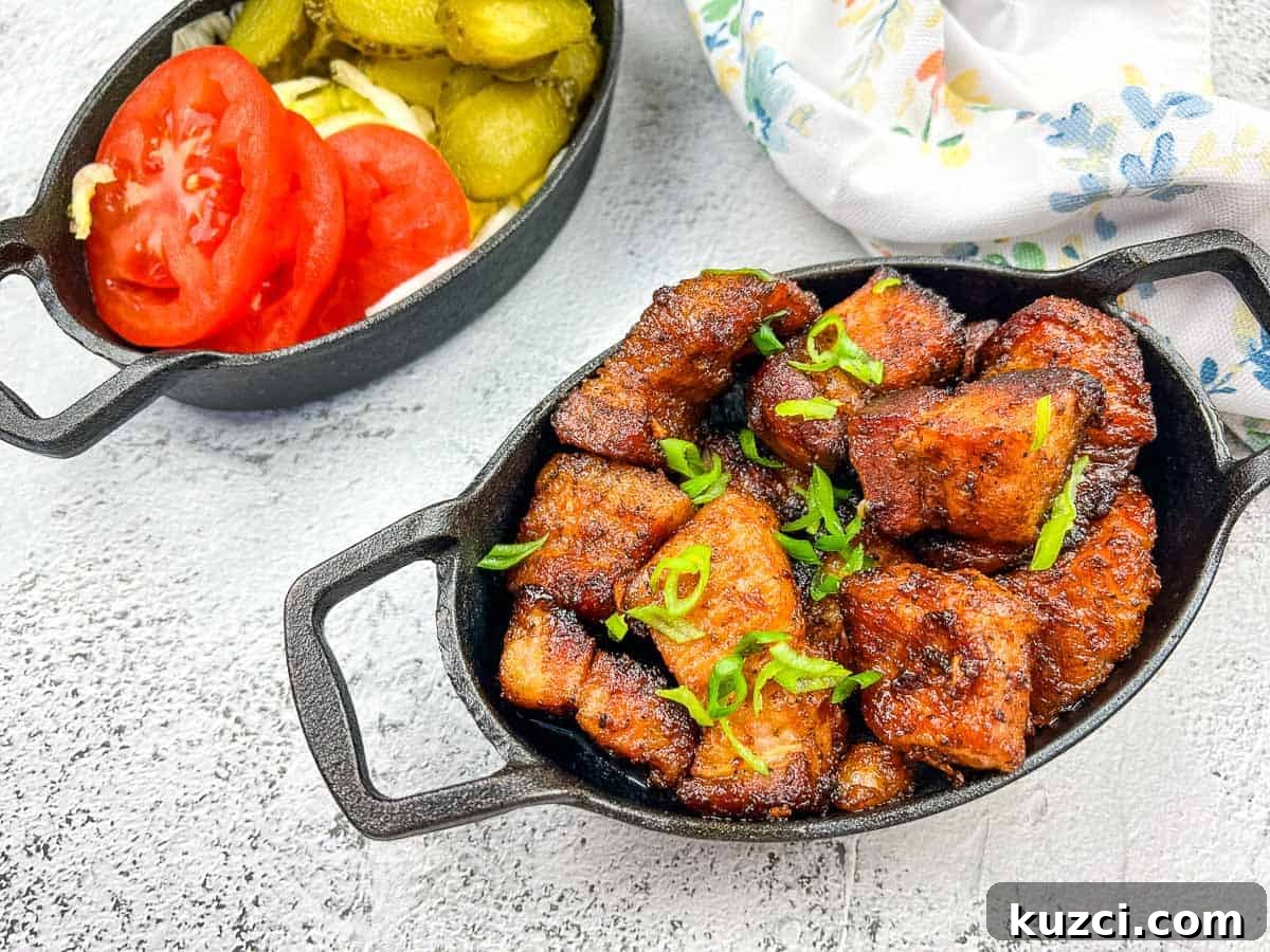 33 Fall Dinner Recipes Packed With Comfort Food Favorites 15 A plate of smoked pork belly burnt ends with tomatoes and pickles.